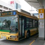 airport shuttle bus waiting outside a terminal