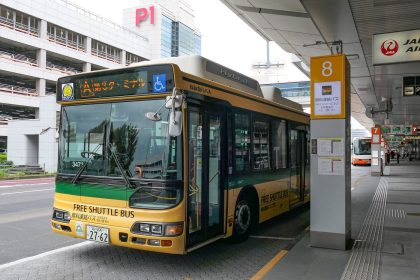 airport shuttle bus waiting outside a terminal