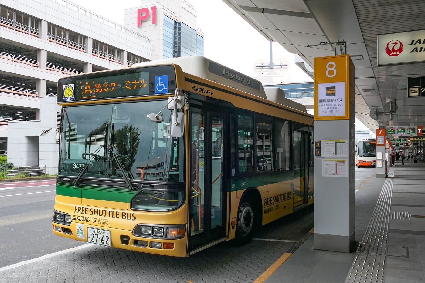 airport shuttle bus waiting outside a terminal