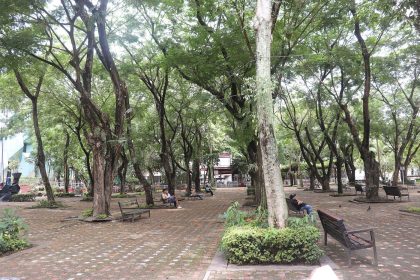 people resting in shade during hot city weather