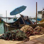 A working fishing boat with nets in Gulf waters