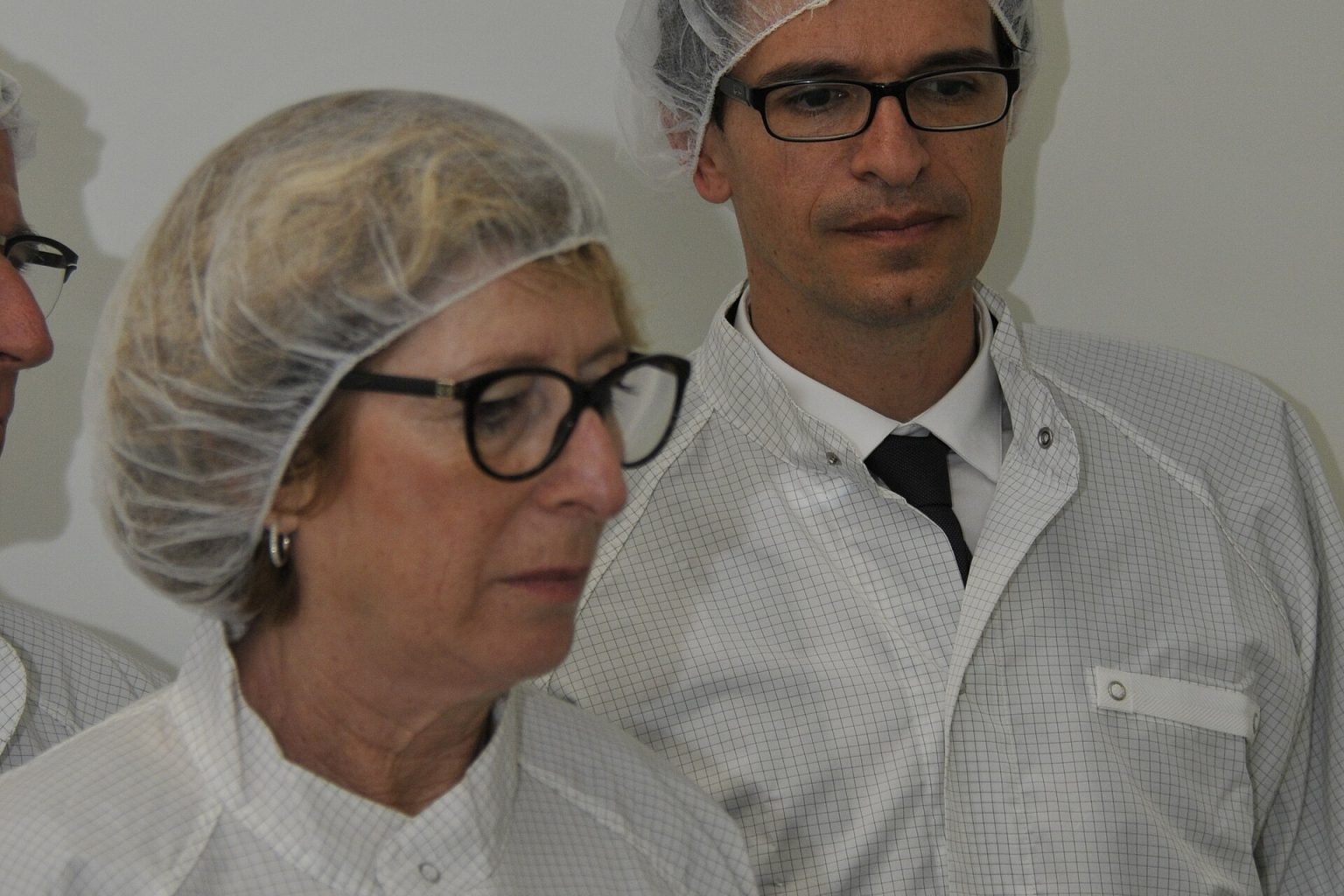 Semiconductor cleanroom engineers working on silicon wafer production lines
