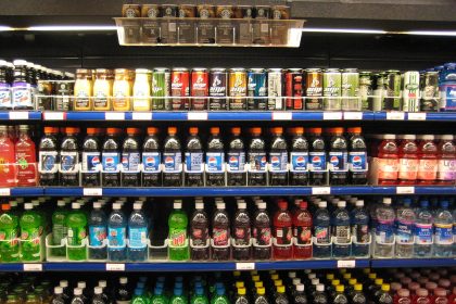Supermarket shelves with packaged foods and nutrition labels being examined