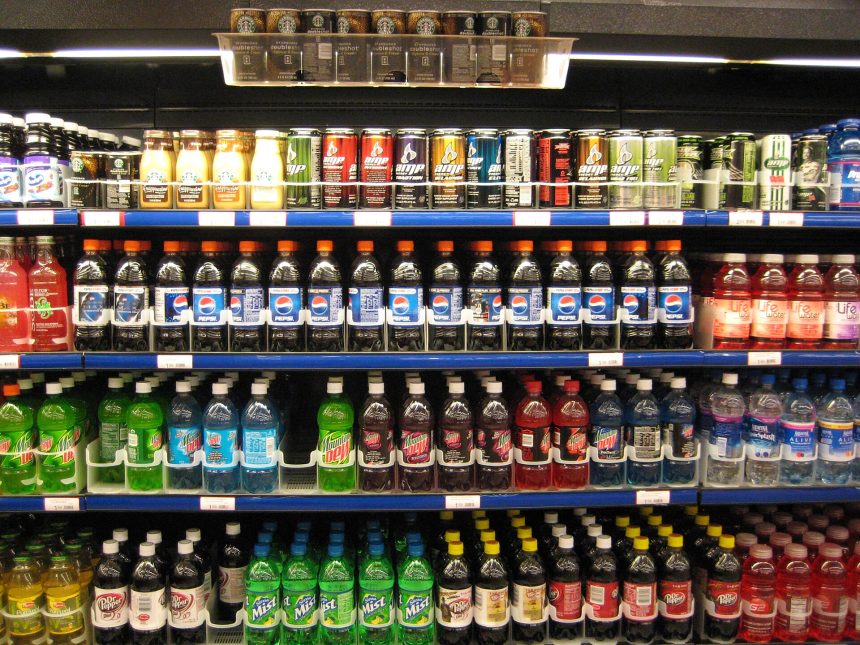 Supermarket shelves with packaged foods and nutrition labels being examined